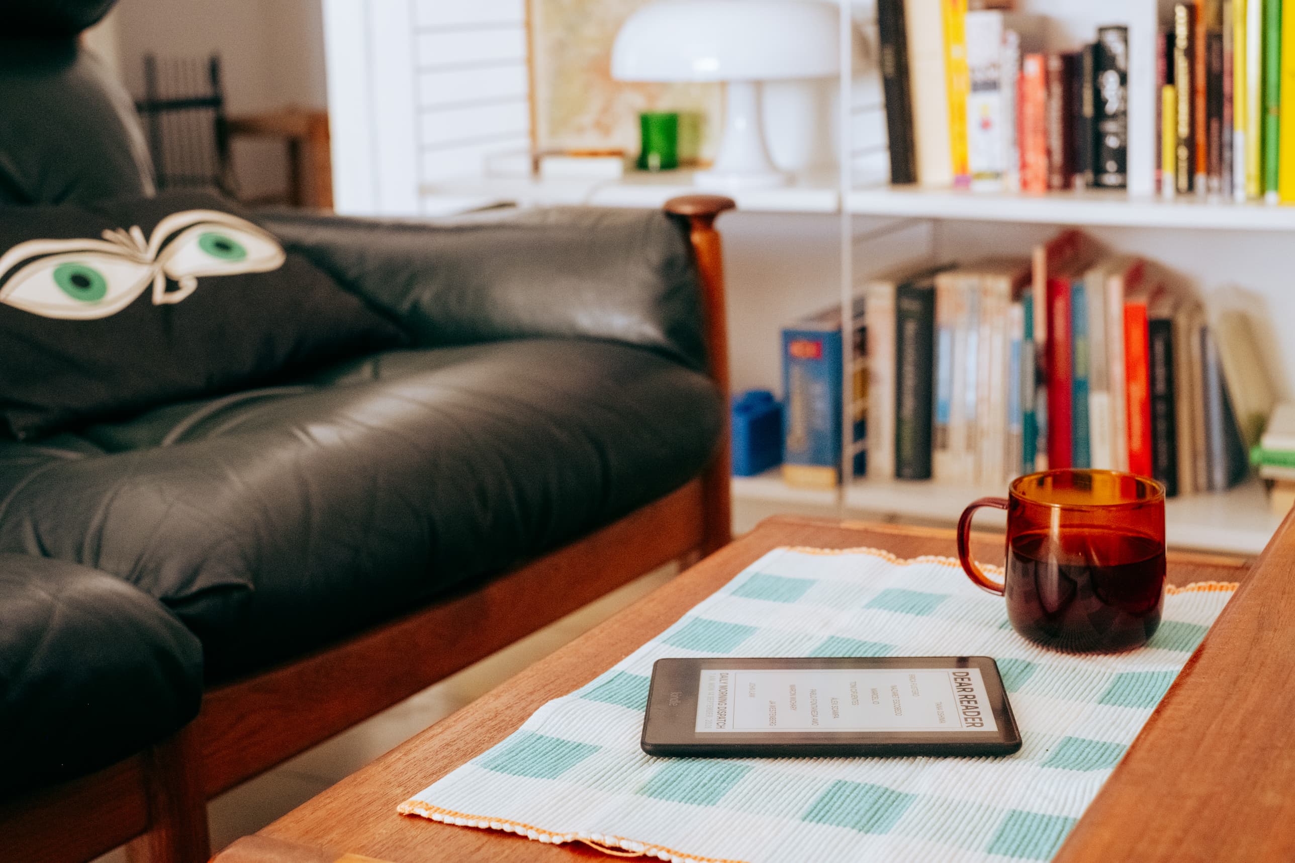 A photograph showing the e-ink reader on a sofa table